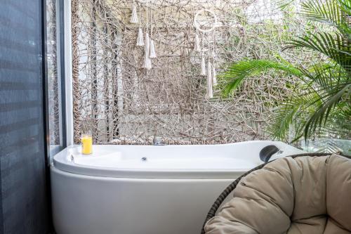 a bath tub in a bathroom with a window at TULUM XAMIRA PRIVATE SPA Balcony in Tulum