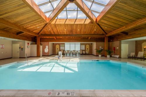 a large swimming pool with a skylight in a building at Sleepy Hollow Hotel, a Dolce by Wyndham in Tarrytown