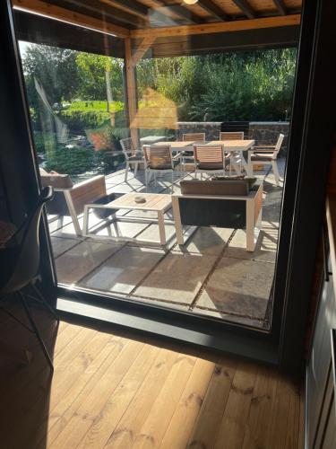 a screened in porch with a table and chairs at Paul Lake Escape in Novosëlki