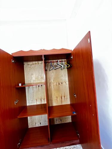 a wooden cupboard with someones items in it at jahazi homes -watamu in Watamu