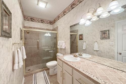 a bathroom with a sink and a shower and a toilet at Charter Landing A10 in Orange Beach