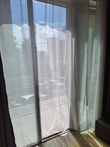a sliding glass door with a view of a window at Hotel Nina in Tbilisi City