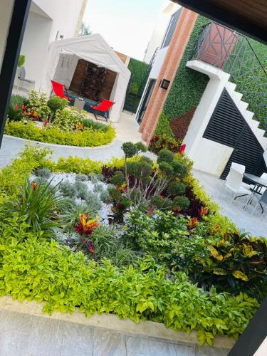 a garden with flowers and plants in front of a building at Love us in Tequisquiapan