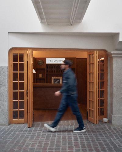 a man walking in front of a building at Hotel Parián in Mexico City