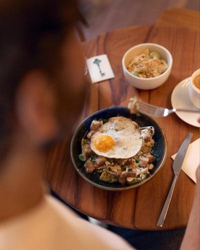 a bowl of food with an egg on a table at Hotel Parián in Mexico City