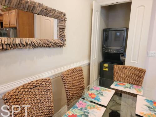 a dining room with a table and chairs and a mirror at Island Time #4 condo in South Padre Island