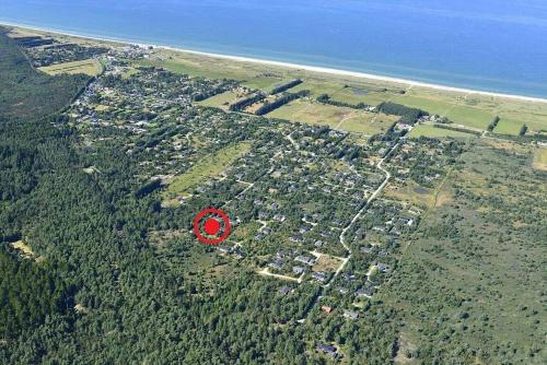 a red frisbee is flying over a city at JB167-Fjerritslev-Revlingestien-83 in Torup Strand