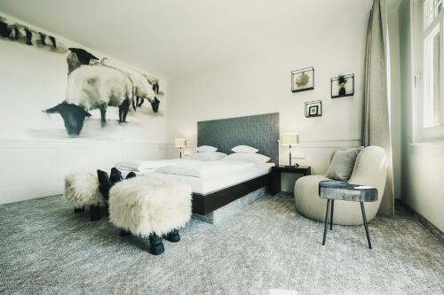 a bedroom with a bed and two sheep in it at Fritz Lauterbad in Freudenstadt