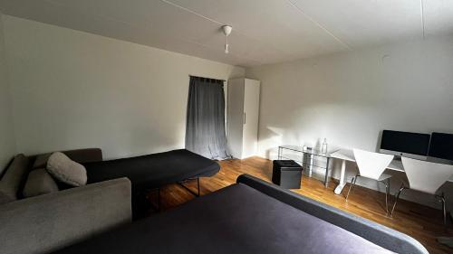 a living room with a couch and a table at Comfort Us in Uppsala