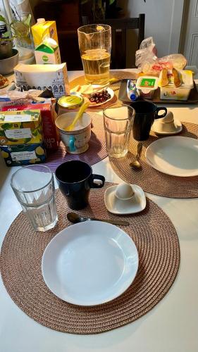 a table with plates and bowls on top of it at The Cozy Little House in Motala