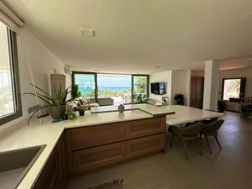 a kitchen with a large island with a counter top at Penthouse Panoramic Ocean Views - By Bobbywashere in Santa Maria