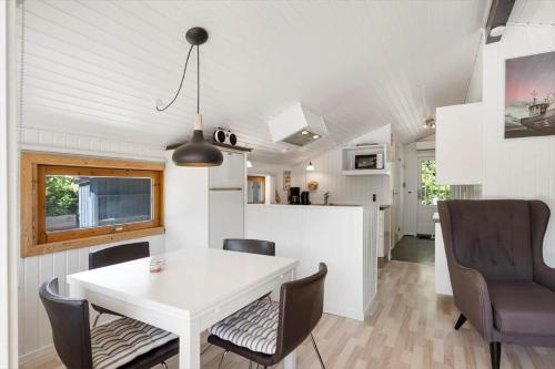 a kitchen and dining room with a white table and chairs at JB272-Fjerritslev-Ronnevej-14 in Fjerritslev