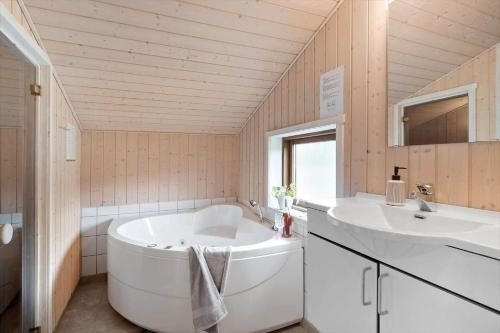 a bathroom with a large tub and two sinks at JB188-Fjerritslev-Kollerup-Klitvej-163 in Fjerritslev