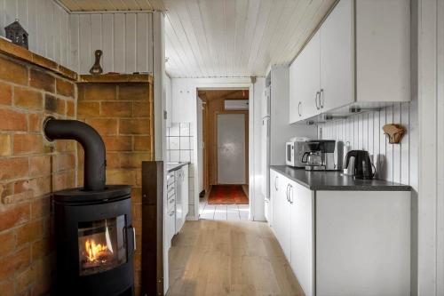 a kitchen with a stove in the middle of a room at JB179-Fjerritslev-Slojbrovej-77 in Gøttrup