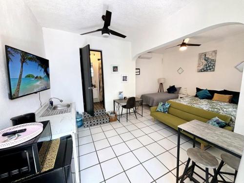 a living room with a couch and a bed at Nueva Vista INN in Cruz de Huanacaxtle
