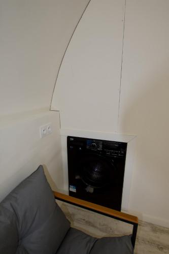 a living room with a couch and a microwave at Studio Egypte in Jougne