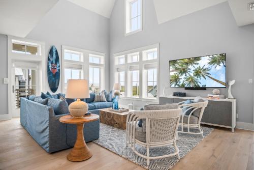 a living room with a blue couch and chairs at Coastal Reverie TC 6301 in Mustang Beach