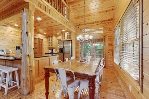a dining room with a wooden table and chairs at Kingfisher Cove Cabin 19 in Saugatuck