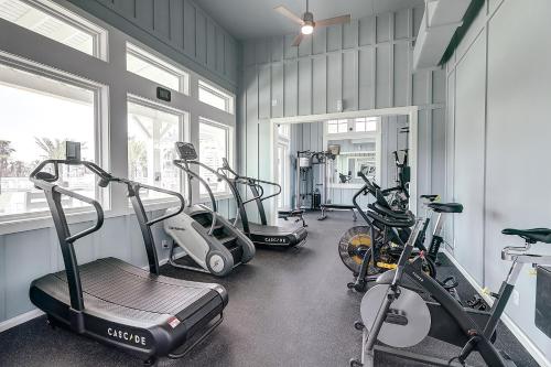 a gym with three tread machines in a room at Coastal Reverie TC 6301 in Mustang Beach