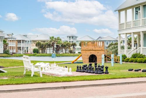 a chess game on a lawn in front of a house at Coastal Reverie TC 6301 in Mustang Beach