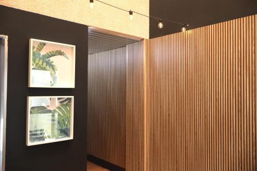 a room with two pictures on a wooden wall at Casa do Balneario in Arnoia