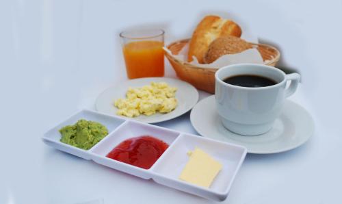 a table with a plate of food and a cup of coffee at 1900 Backpacker's Hostel in Lima