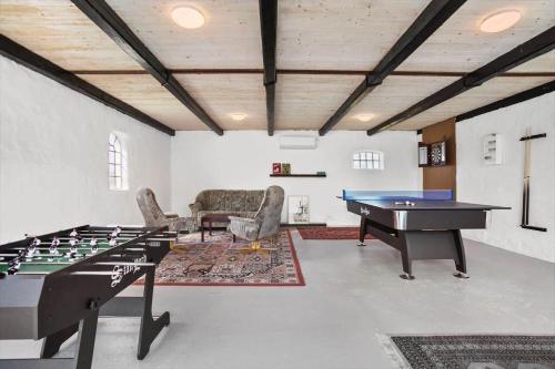 a living room with a ping pong table and a couch at JB200-Fjerritslev-Udklitvej-168 in Fjerritslev