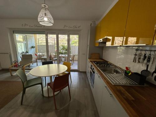 a kitchen with a table and a table and chairs at Marina Holiday Home in Pizzo