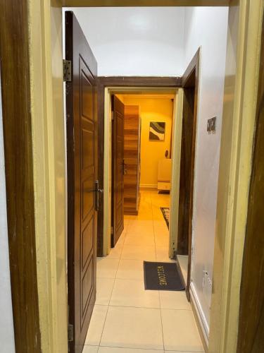 a hallway with a door and a tiled floor at AHIL apartments in Kano