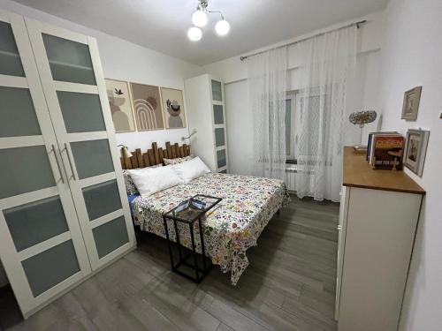 a small bedroom with a bed and a table at Marina Holiday Home in Pizzo