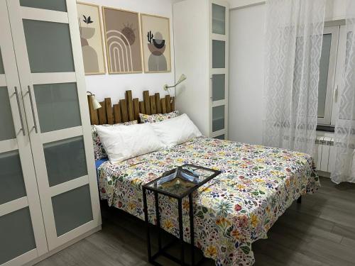 a small bedroom with a bed and a table at Marina Holiday Home in Pizzo