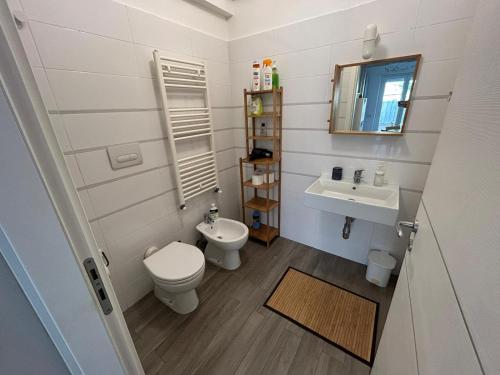 a small bathroom with a toilet and a sink at Marina Holiday Home in Pizzo