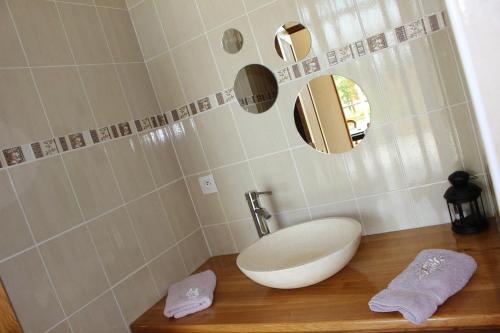 a bathroom with a white sink and a mirror at Gite du Perche in Saint-Ouen-de-Sècherouvre