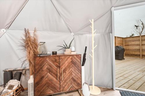 a marquee with a wooden door in a room at Nalu Retreat Glamping Domes in Porters Lake