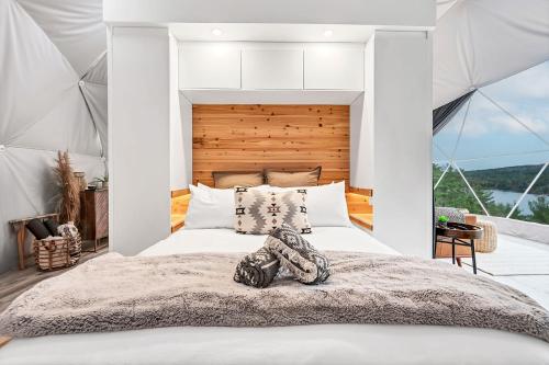 a bedroom with a large bed in a tent at Nalu Retreat Glamping Domes in Porters Lake