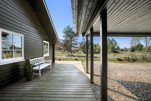 a porch with a bench on the side of a house at JB228-Brovst-Ildervej-14 in Tranum
