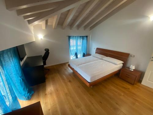 a bedroom with a bed and a desk in it at Villa Sabina in Lido di Camaiore
