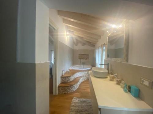 a white bathroom with a sink and a tub at Villa Sabina in Lido di Camaiore