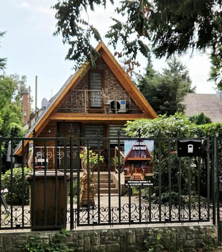 a small house with a fence in front of it at Napsugár Kakasvár in Orosháza