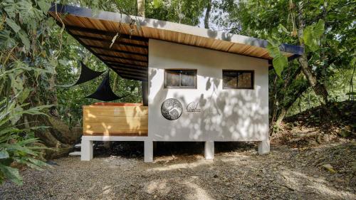 a small house in the middle of a forest at Casita SAMSARI in Punta Uva