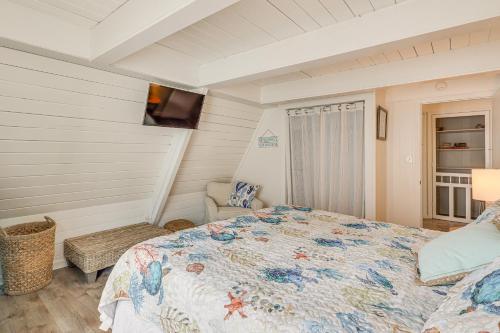 a bedroom with a bed and a television in it at Unique A-Frame Beach House The Beacon at OIB in Ocean Isle Beach