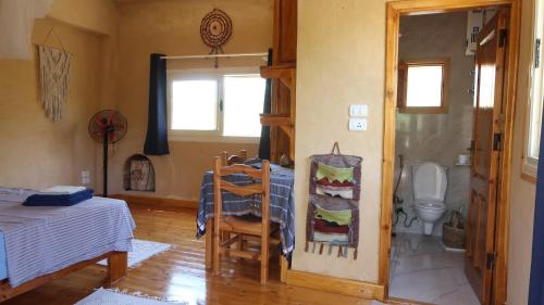 a room with a bed and a bathroom with a toilet at Spellbound in Siwa in Siwa