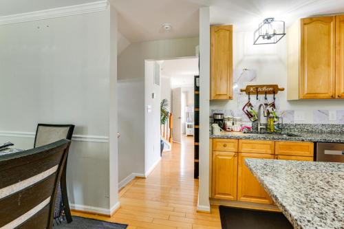 a kitchen with wooden cabinets and a wooden floor at Less Than 2 Mi to Dtwn Hagerstown Townhome with Fireplace in Hagerstown