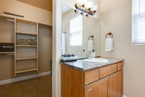 a bathroom with a sink and a mirror at Home with Game Room Near Zion National Park! in Hurricane