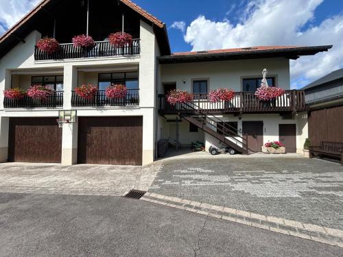 a house with flowerpots on the balconies of it at Geyershof Country Retreat 