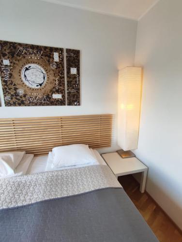 a bedroom with a bed and a picture on the wall at Wilde Guest Apartment Tigutorn in Tartu