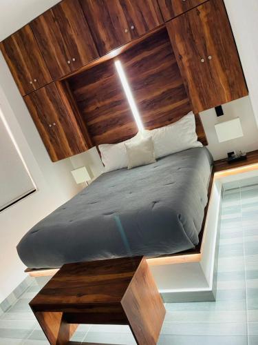 a bed in a room with a wooden ceiling at Casa Love Us in Tequisquiapan