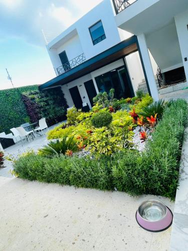a flower garden in front of a house at Casa Love Us in Tequisquiapan