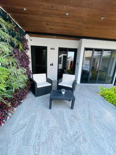a patio with two chairs and a table at Casa Love Us in Tequisquiapan