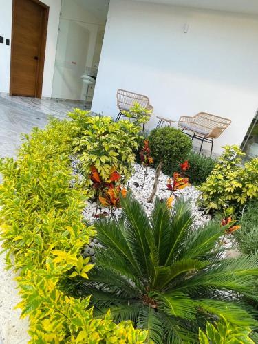 a garden with benches and flowers in a building at Casa Love Us in Tequisquiapan